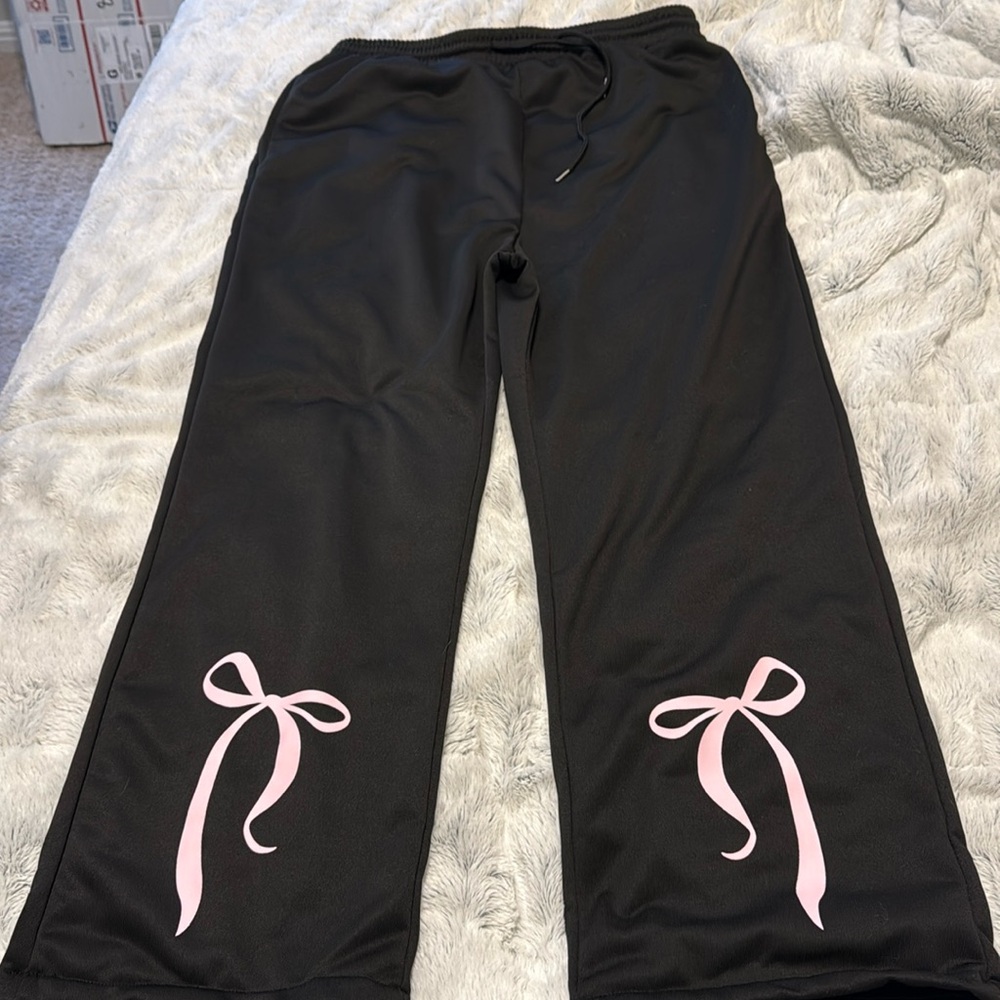 Black sweatpants with pink bowtie at the bottom